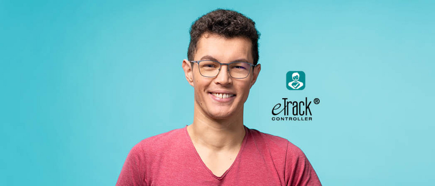 Smart Patient Smiling patient wearing glasses and a red t-shirt against a blue background, looking at the camera.